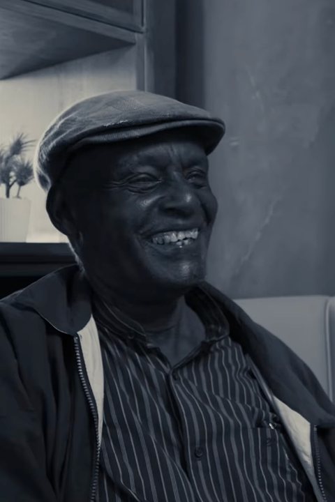 Mzee Daniel laughing during an interview